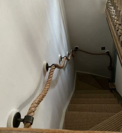 A custom-made, bespoke manila rope handrail/banister for a flight of stairs.